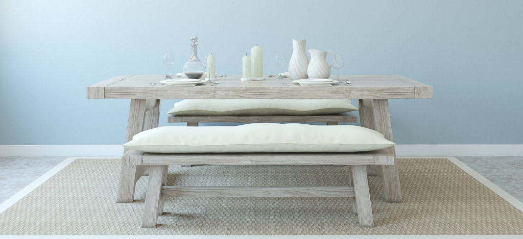 A wooden table with two chairs and a vase on it.