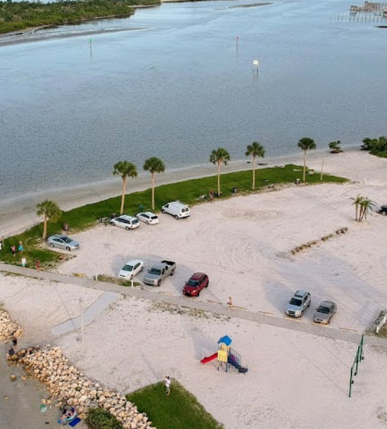 An aerial view of a parking lot near the beach.