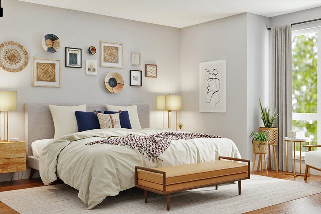 A bedroom with a bed, dresser, and framed pictures.