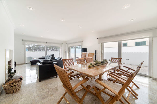 A living room with a dining table and chairs.